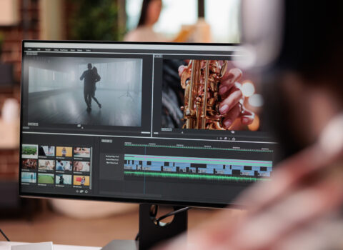 Young freelancer editing footage on software